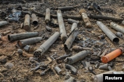 Ammunition shells are strewn around the scene of a fire and explosions at a military ammunition depot in N'Djamena, Chad, June 19, 2024.