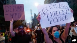 A protester carries a sign, June 5, 2020, in New York, in memory of Breonna Taylor, a 26-year-old woman who was fatally shot by Louisville Metro Police Department officers