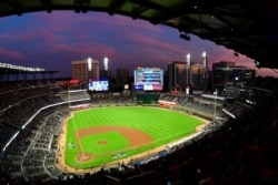 FILE - Ground crews work at Sun Trust Park, now known as Truist Park, in Atlanta, Oct. 7, 2018. Truist Park lost the 2021 All-Star Game on April 2, when Major League Baseball moved the game over the objections to Georgia's new election law.