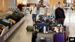 Unclaimed bags sit in baggage claim at Hartsfield-Jackson Atlanta International Airport in Atlant. Atlanta's city council has approved a far-reaching ban on smoking and vaping in restaurants, bars and inside the airport.