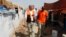 FILE - The secretary-general of the Norwegian Refugee Council (NRC), Jan Egeland (front) visits Domiz camp in the northern Iraqi province of Dohuk, Aug. 21, 2013. 