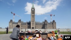 FILE - Canadian Prime Minister Justin Trudeau visits the makeshift memorial erected in honor of the 215 Indigenous children remains found at a boarding school in British Columbia, on Parliament Hill June 1, 2021, in Ottawa.