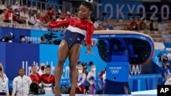 Simone Biles, of the United States, lands from the vault during the artistic gymnastics women's final at the 2020 Summer Olympics, Tuesday, July 27, 2021, in Tokyo. (AP Photo/Gregory Bull)