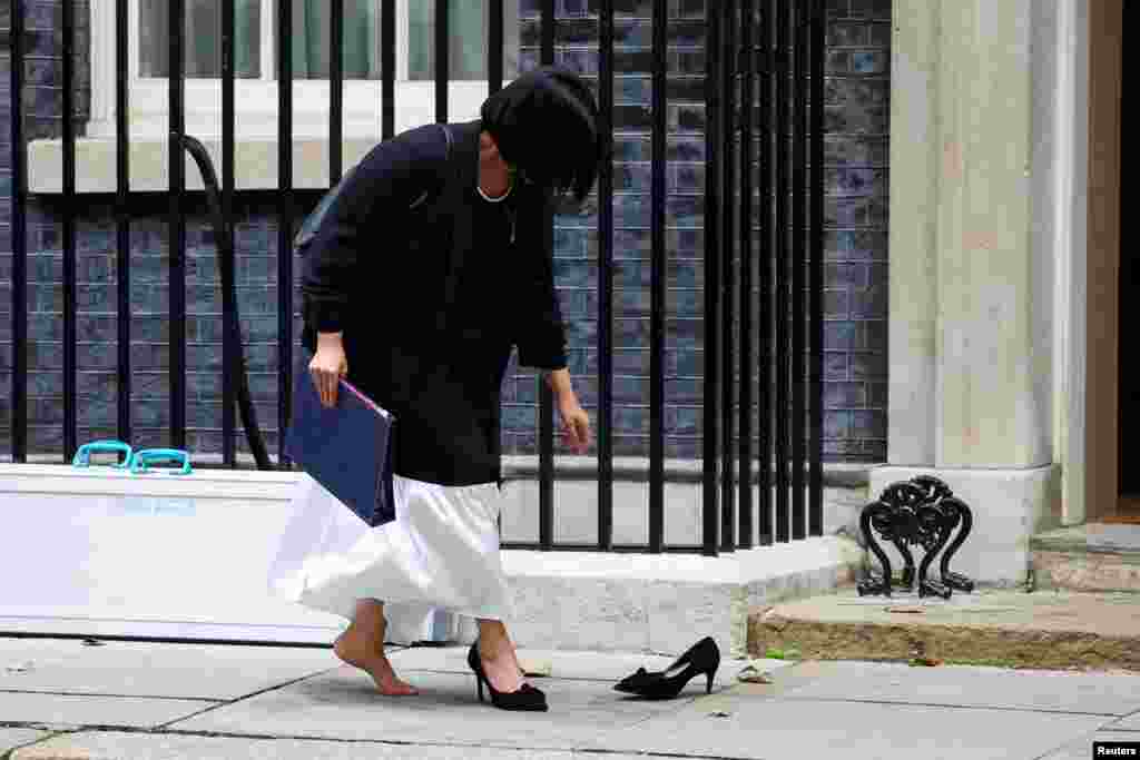 Britain&#39;s Lord Chancellor and Secretary of State for Justice Shabana Mahmood retrieves her shoe after losing it from her foot, outside 10 Downing Street in London.