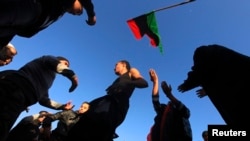 People dance as they mark the second anniversary of the country's revolution in Benghazi, Feb. 16, 2013.