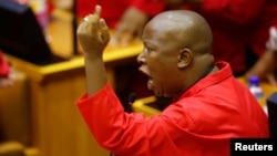 FILE - Julius Malema, leader of the Economic Freedom Fighters (EFF) party, raises objections before being evicted from Parliament during President Jacob Zuma's question and answer session in Cape Town, South Africa, May 17, 2016. 