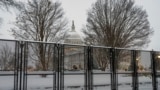 Security fencing surrounds Capitol Hill as snow blankets the region ahead of a joint session of Congress to certify the votes from the Electoral College in the presidential election, in Washington, Monday, Jan. 6, 2025. (AP Photo/J. Scott Applewhite)