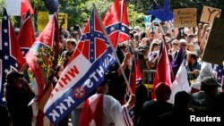 Members of the Ku Klux Klan face counter-protesters as they rally in support of Confederate monuments in Charlottesville, Virginia, July 8, 2017. 