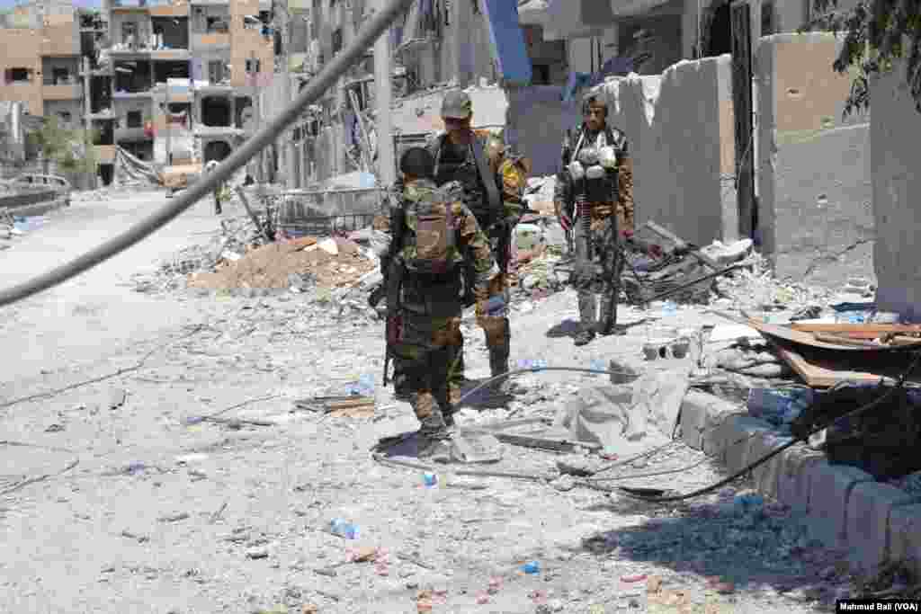South Korean environmental activists wearing black cloth perform to represent the burning Earth during a protest marking a global climate action day in Seoul.
