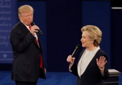 FILE - Republican presidential nominee Donald Trump and Democratic presidential nominee Hillary Clinton speak during the second presidential debate at Washington University in St. Louis, Oct. 9, 2016.
