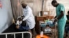 Medics treat a man wounded during fighting between Congolese government troops and M23 rebel forces in Goma's Kyeshero hospital, Feb. 1, 2025. 