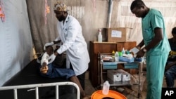 Medics treat a man wounded during fighting between Congolese government troops and M23 rebel forces in Goma's Kyeshero hospital, Feb. 1, 2025. 