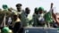 Zimbabwean President Robert Mugabe (C) and his wife Grace wave to supporters at an election rally in Chitungwiza, about 35 kilometers south of the capital Harare, July 16, 2013.