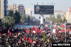 Iranian people attend a funeral procession and burial for Iranian Major-General Qassem Soleimani, head of the elite Quds Force, who was killed in an airstrike at Baghdad airport, at his hometown in Kerman, Iran, Jan. 7, 2020.