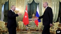 Presiden Rusia, Vladimir Putin, kiri, menghampiri Presiden Turki, Reccep Tayyip Erdogan, kanan, untuk berjabatan tangan sebelum melaksanakan pertemuan di Moskow, Rusia, Senin, 8 April 2019 (Biro Pers Kepresidenan Rusia via AP, Pool)