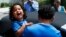FILE - Ever Reyes Mejia of Honduras carries his son to a vehicle after being reunited and released by United States Immigration and Customs Enforcement in Grand Rapids, Mich., July 10, 2018. The Trump administration is one month past a deadline to reunite the rest of the separated families.