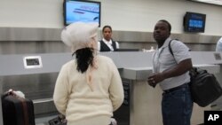 Passengers checking in for American Airlines' first commercial flight out of Miami International Airport since the January 12 earthquake