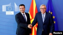 North Macedonia Prime Minister Zoran Zaev shakes hands with European Commission President Jean-Claude Juncker at the EU Commission headquarters in Brussels, Belgium, June 4, 2019.