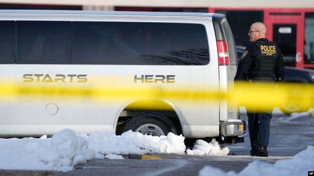 A law enforcement officer walks outside the Starts Right Here building, Jan. 23, 2023, in Des Moines, Iowa. Police say two students were killed and a teacher was injured in a shooting at the Des Moines school.
