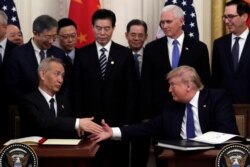 FILE - President Donald Trump shakes hands with Chinese Vice Premier Liu He, after signing a trade agreement in the East Room of the White House, Jan. 15, 2020.