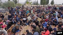 Mourners attend the funeral of Raed Fares and Hamod Jneid in the village of Kafranbel in the northwestern province of Idlib, Nov. 23, 2018. Two activists critical of the regime and jihadists were gunned down Friday in Syria's last major rebel bastion in the country's northwest.