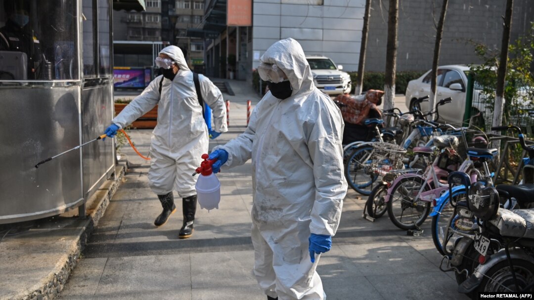 Health emergency crew disinfect an area in Wuhan, China during the coronavirus outbreak