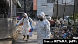 Une équipe d'assainissement désinfecte une rue à Wuhan, en Chine, le 30 janvier 2020.