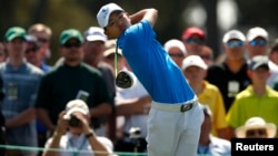 Asia-Pacific Amateur Championship winner, 14-year-old Guan Tianlang of China hits his tee shot on the first hole during a practice round in preparation for the 2013 Masters tournament at Augusta National Golf Club in Augusta, Georgia, Apr. 9, 2013.