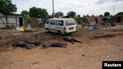 The bodies of civiliansline a road in Bentiu, Unity state last year. South Sudan Information Minister Michael Makuei defends an African Union decision to delay a report on rights violations during South Sudan's conflict.