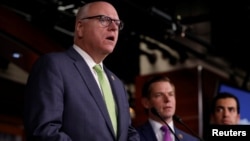 FILE - Rep. Ruben Kihuen (R) and Rep. Eric Swalwell (C) listen as Rep. Joe Crowley addresses recent revelations about President Donald Trump's involvement with Russia on Capitol Hill in Washington, D.C., U.S. May 17, 2017. 