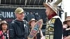 FILE - Rear Adm. Mark Sucato is gifted a canoe paddle by Leonard John, Raven Clan, Native Village of Angoon, following a welcoming ceremony to kick off the annual Juneau Maritime Festival on May 4, 2024, in Juneau, Alaska. 