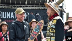 FILE - Rear Adm. Mark Sucato is gifted a canoe paddle by Leonard John, Raven Clan, Native Village of Angoon, following a welcoming ceremony to kick off the annual Juneau Maritime Festival on May 4, 2024, in Juneau, Alaska. 