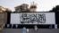 The iconic Taliban flag is painted on a wall outside the American embassy compound in Kabul, Afghanistan, Sept. 11, 2021.