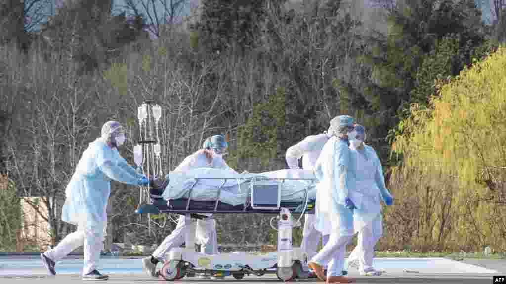 Medical staff push a patient on a gurney to a waiting medical helicopter at the Emile Muller hospital in Mulhouse, eastern France, amid the coronavirus pandemic.