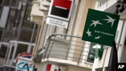 FILE - Logos of French banks Credit Agricole, left, societe Generale and BNP Paris are seen in Rennes, western France, Sept. 26, 2011.