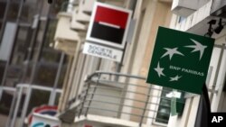 FILE - Logos of French banks Credit Agricole, left, Societe Generale and BNP Paris are seen in Rennes, western France, Sept. 26, 2011.