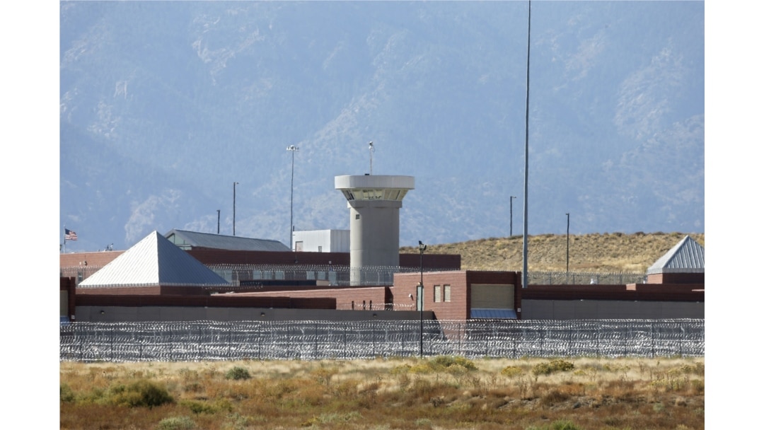 FILE - This Oct. 15, 2015 file photo shows a guard tower looming over a federal prison complex which houses a Supermax facility outside Florence, Colorado.