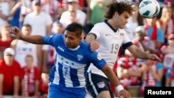 Emilio Izaguirre, de Honduras, y Graham Zusi de EE.UU. disputan un balón en el partido que se llevaron los estadounidenses por la mínima.