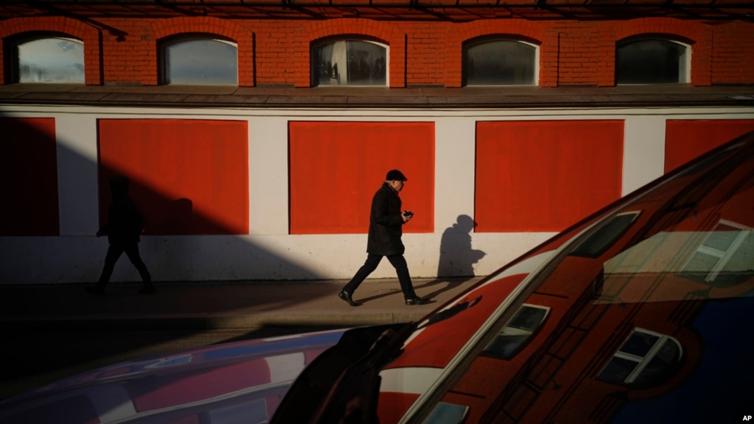 People walk in a street on a sunny day in Moscow, Feb. 25, 2025. 