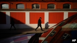 People walk in a street on a sunny day in Moscow, Feb. 25, 2025. 