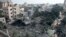 Palestinians gather at the site of an Israeli strike on a house, in Deir Al-Balah