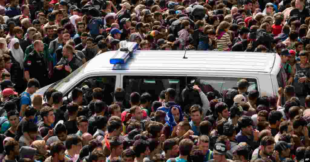 Migrants queue up for busses after they arrived at the border between Austria and Hungary near Heiligenkreuz, about 180 kms (110 miles) south of Vienna. Thousands of migrants who had been stuck for days in southeastern Europe started arriving in Austria early Saturday after Hungary escorted them to the border.