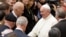FILE - Pope Francis shakes hands with then U.S. Vice President Joe Biden as they take part in a conference being held at the Vatican, April 29, 2016. 