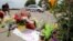 A man kneels at a make-shift memorial at the site of the police shooting of Philando Castile in Falcon Heights, Minnesota, July 7, 2016.