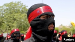 Iraqi Shi'ite Muslim men from Hashid Shaabi (Popular Mobilization) march during a parade marking the annual al-Quds Day, or Jerusalem Day, on the last Friday of the Muslim holy month of Ramadan in Baghdad, July 10, 2015.