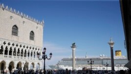 In this file photo, a cruise ship passes by St. Mark's Square in Venice, Italy, Sunday, June 2, 2019. )AP Photo/Luca Bruno)