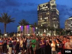 People gather outside the Dr Phillips Center for Performing Art in Orlando for a vigil for the victims and the injured of Orlando nightclub shooting. (S. Dizayee/VOA)