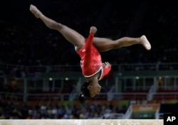 FILE - United States' Simone Biles performs on the balance beam during the artistic gymnastics women's apparatus final at the 2016 Summer Olympics in Rio de Janeiro, Brazil, Aug. 15, 2016.