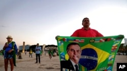 Demonstrators pray in support of Brazil's President Jair Bolsonaro in front of the Planalto presidential palace, in Brasilia, Brazil, March 29, 2021.