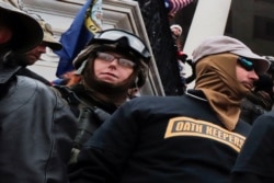 FILE - Members of the Oath Keepers militia group stand among supporters of then-President Donald Trump protesting the certification of the 2020 presidential election results on the east front steps of the Capitol, Jan. 6, 2021.